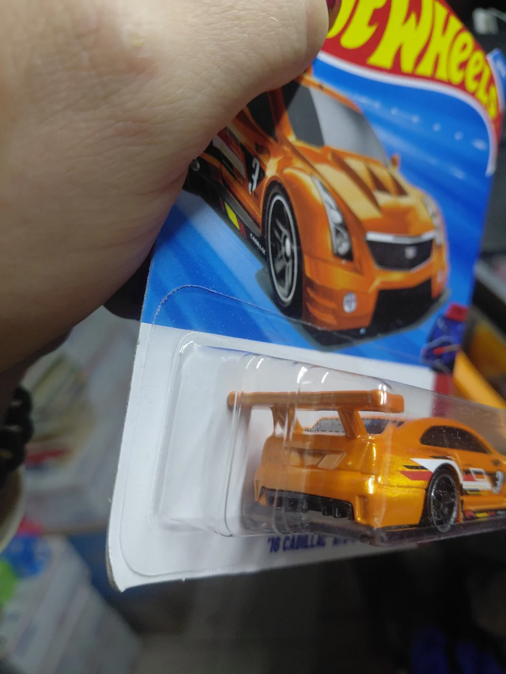 The Hot Wheels '16 Cadillac ATS-V R (orange, 90/250) is a 1:64 scale diecast car